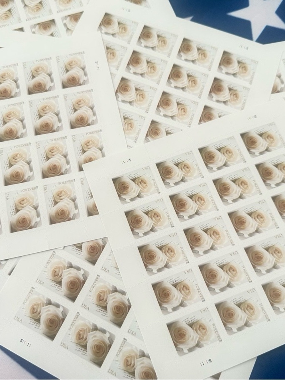 These are 200 unused wedding-themed white rose stamps.